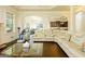 Open-concept living room with hardwood floors, a coffered ceiling, and large windows allowing ample sunlight at 2589 Lake Erma Dr, Hampton, GA 30228