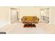 Open living room with neutral carpet, a comfortable sofa, and views of the staircase at 2589 Lake Erma Dr, Hampton, GA 30228