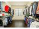 A well-organized walk-in closet featuring shelving and hanging rods at 2589 Lake Erma Dr, Hampton, GA 30228
