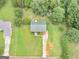 Aerial view of a home featuring a green shingled roof, a driveway, and lush surrounding greenery at 140 Joshua St, Palmetto, GA 30268