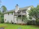 Back exterior view of a two-story house with a deck, a door to the basement and a grassy yard at 140 Joshua St, Palmetto, GA 30268