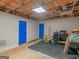 Spacious unfinished basement with blue doors and natural light from a window at 140 Joshua St, Palmetto, GA 30268