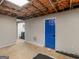 Spacious unfinished basement with blue door and natural light at 140 Joshua St, Palmetto, GA 30268