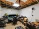 View of unfinished basement, which includes an entertainment center, exposed ceiling, and a window at 140 Joshua St, Palmetto, GA 30268
