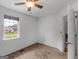 This bedroom features neutral carpeting, white walls and trim and a window with a view at 140 Joshua St, Palmetto, GA 30268