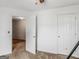 This bedroom features neutral carpeting, white walls and trim and two doorways and an entry closet at 140 Joshua St, Palmetto, GA 30268