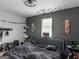 A modern bedroom with dark wall, black ceiling fan, and decor at 140 Joshua St, Palmetto, GA 30268