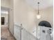 Bright foyer showcasing a staircase with white railings, a pendant light, and a front door at 140 Joshua St, Palmetto, GA 30268
