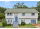 Charming two-story home with blue door, light-colored siding, and a green shingled roof at 140 Joshua St, Palmetto, GA 30268