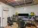 An oddly finished hobby room with exposed ceiling, computers, monitors and speakers at 140 Joshua St, Palmetto, GA 30268