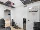 An oddly finished hobby room with an exposed ceiling, water cooler, and doorway to an adjacent room at 140 Joshua St, Palmetto, GA 30268