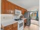 An efficient kitchen showcasing wood cabinets, white countertops, and modern stainless steel appliances at 140 Joshua St, Palmetto, GA 30268
