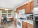 Charming kitchen features wooden cabinets, laminate countertops, and stainless steel appliances at 140 Joshua St, Palmetto, GA 30268