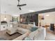 Large living room features sectional sofa, ceiling fan, chalk wall, and open view of dining area at 140 Joshua St, Palmetto, GA 30268