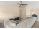 Bright living room features a sectional sofa, a ceiling fan, and views of the upstairs hallway at 140 Joshua St, Palmetto, GA 30268