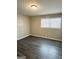 Bedroom featuring gray walls and dark flooring with a window at 599 Cherry Ln, Jonesboro, GA 30238