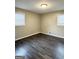 Bedroom featuring gray walls and dark flooring with two windows at 599 Cherry Ln, Jonesboro, GA 30238