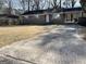 Brick home featuring a covered carport and a long concrete driveway at 599 Cherry Ln, Jonesboro, GA 30238