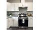 Stainless steel stove with white cabinets and granite countertops at 599 Cherry Ln, Jonesboro, GA 30238