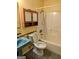 Small bathroom with a blue sink, toilet, and tub/shower combo at 60 Doe Run Dr, Sharpsburg, GA 30277