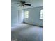 Bedroom with carpet, white walls, and multiple windows for natural light at 60 Doe Run Dr, Sharpsburg, GA 30277