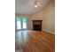 Light-filled living room featuring hardwood floors, ceiling fan, fireplace, and french doors at 60 Doe Run Dr, Sharpsburg, GA 30277