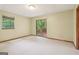 Bedroom with neutral carpet, sliding glass doors to a deck, and natural light from the window at 497 Fire Fly Dr, Tucker, GA 30084