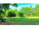 Lush backyard featuring a well-maintained lawn, mature trees, and serene natural surroundings at 530 Austin Dr, Mcdonough, GA 30252