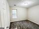 Cozy bedroom featuring neutral walls, plush carpeting, and a window providing natural light at 530 Austin Dr, Mcdonough, GA 30252