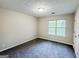 A light and airy bedroom with carpet floors and a large window at 530 Austin Dr, Mcdonough, GA 30252