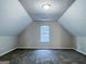 Bonus room featuring neutral walls, plush carpeting, a window providing natural light, and a vaulted ceiling at 530 Austin Dr, Mcdonough, GA 30252