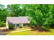 Well-maintained home with a blend of siding and brick, nestled among mature trees and manicured landscaping at 530 Austin Dr, Mcdonough, GA 30252