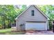 Exterior view of garage and porch surrounded by mature trees at 530 Austin Dr, Mcdonough, GA 30252