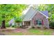 Charming single-Gathering home featuring brick and siding exterior, complemented by lush landscaping and mature trees at 530 Austin Dr, Mcdonough, GA 30252