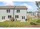 Exterior showcasing a gray home with a small grassy backyard, wooden fence, and outdoor grill at 109 Feeney Lane, Villa Rica, GA 30180