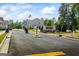 Community entrance featuring a stone sign, manicured landscaping, and an American flag waving in the wind at 109 Feeney Lane, Villa Rica, GA 30180