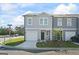 Charming two-story townhome with gray siding, a one-car garage, and a manicured front yard at 109 Feeney Lane, Villa Rica, GA 30180