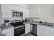 Stylish kitchen with stainless steel appliances, white cabinetry and granite countertops at 109 Feeney Lane, Villa Rica, GA 30180