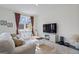 Bright living room with white couch, TV, soft rug, and large window at 109 Feeney Lane, Villa Rica, GA 30180