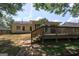 Backyard view featuring a wooden deck, lush greenery, and stepping stone path at 254 Roberts Trl, Locust Grove, GA 30248