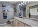 Well-lit bathroom with a spacious vanity, a large mirror, and wall decor at 254 Roberts Trl, Locust Grove, GA 30248