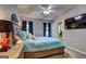 Cozy bedroom with a ceiling fan, soft bedding, and decor at 254 Roberts Trl, Locust Grove, GA 30248