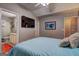Well-lit bedroom featuring a TV, ensuite bath, and comfortable bed at 254 Roberts Trl, Locust Grove, GA 30248