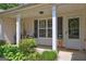 Charming front porch with seating area, decorative wreath, and a welcoming entrance at 254 Roberts Trl, Locust Grove, GA 30248