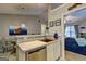 Open concept kitchen featuring stainless steel dishwasher and bar top view to living room at 254 Roberts Trl, Locust Grove, GA 30248