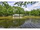 Picturesque lake view lined with trees and lakeside homes at 254 Roberts Trl, Locust Grove, GA 30248