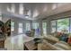 Spacious living room with a ceiling fan, multiple windows, and stylish decor at 254 Roberts Trl, Locust Grove, GA 30248