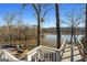 Lake view backyard with wooden steps, a seating area, and trees at 405 Miller Rd, Covington, GA 30014