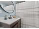 Bathroom featuring a sliding door vanity and shower with decorative curtain, creating a modern design at 405 Miller Rd, Covington, GA 30014