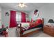 Comfortable bedroom with a ceiling fan, window, and sports themed decorations at 405 Miller Rd, Covington, GA 30014